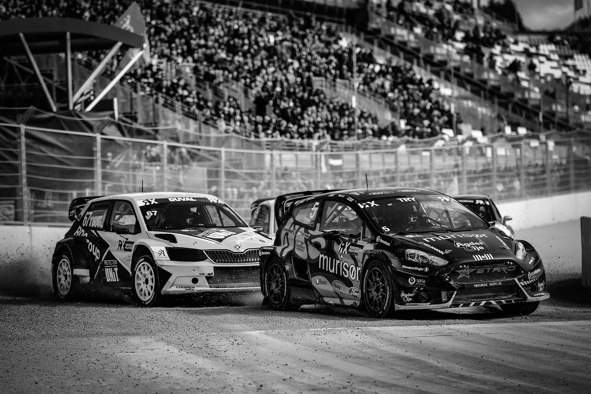 Rallycross car kicking dirt on turn